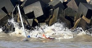 Sailor rescued from yacht stranded on rocks as waves batter vessel