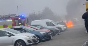 Car ravaged by fire near shop