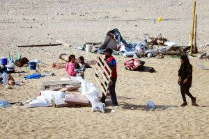Afraid and angry, Lebanese gather on a Beirut beach after fleeing suburbs en masse