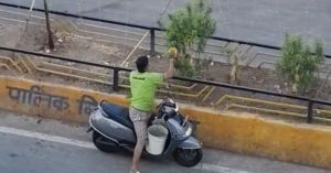 Watch: Man Stops His Bike Every Morning to Water Divider Plants Before Work
