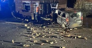 Man arrested after van smashes into homes and sends lamppost flying through air