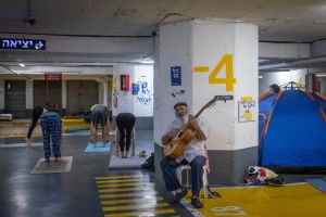 Half-asleep, sheltering underground: Tel Aviv residents seek normalcy under rocket fire