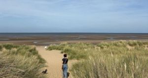 Which beaches in Norfolk are dog-friendly all year round?
