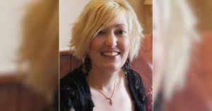 Investigation continues into death of woman found dead next to major road