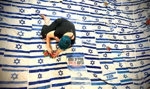 Using discarded Israeli flags, artist tries to stitch divided country together