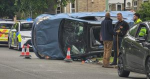 Dramatic photos show wrecked car flipped on its side after crash