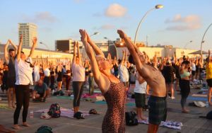 Yoga enthusiasts salute the Tel Aviv sun