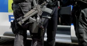 Three men charged after series of armed police raids across city