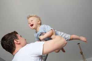Dad expertly, and with comedic flair, demonstrates how to safely roughhouse with a baby