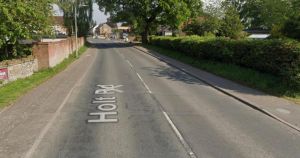 Main road blocked after crash between car and van