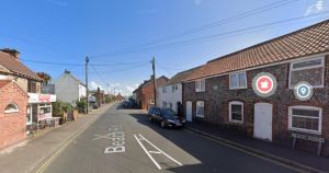 Car on its roof causes road down to beach to close
