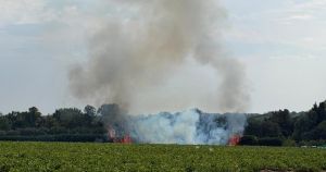 Firefighters battle blaze in village field for more than five hours