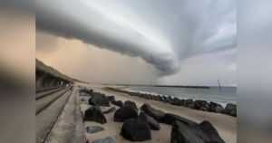 Dramatic storm cloud forms over beach as heavy rain hits Norfolk