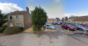 House could be knocked down to extend used car lot in village