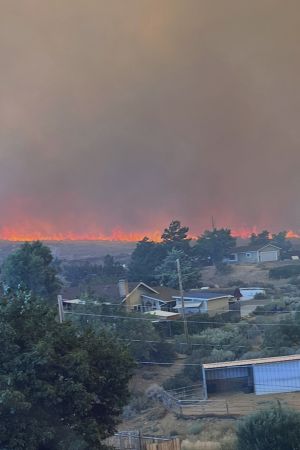 Firefighters battle fast-moving Reno wildfire, 90,000 urged to leave homes