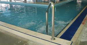 Couple caught being intimate in water at family-friendly swimming pool