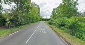 Road closed after crash leaves car on its side
