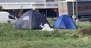 Tents, Christmas tree and shopping trolley appear in the middle of city roundabout