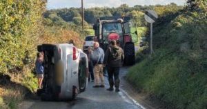 Car flips onto side as incident shuts village road